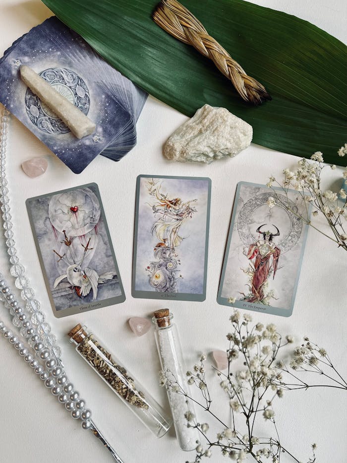 Beautiful Tarot Spread on Table with Herbs and Crystals